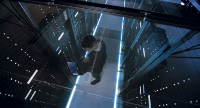 Man standing in data centre surveying security