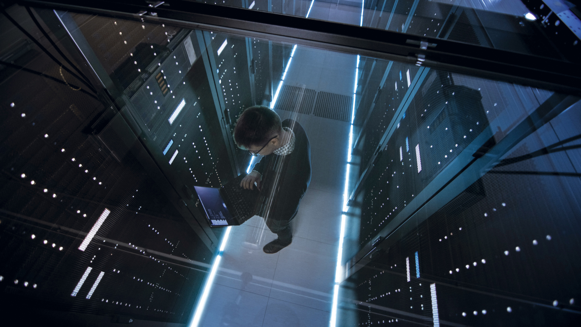 Man standing in data centre surveying security